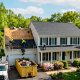 Roofing crew replacing shingles on a Northern Virginia colonial home in spring
