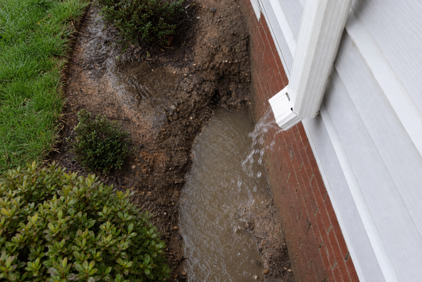 Foundation water damage and soil erosion caused by failing gutters