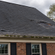 Damaged asphalt shingle roof on a Northern Virginia home showing signs you need a new roof