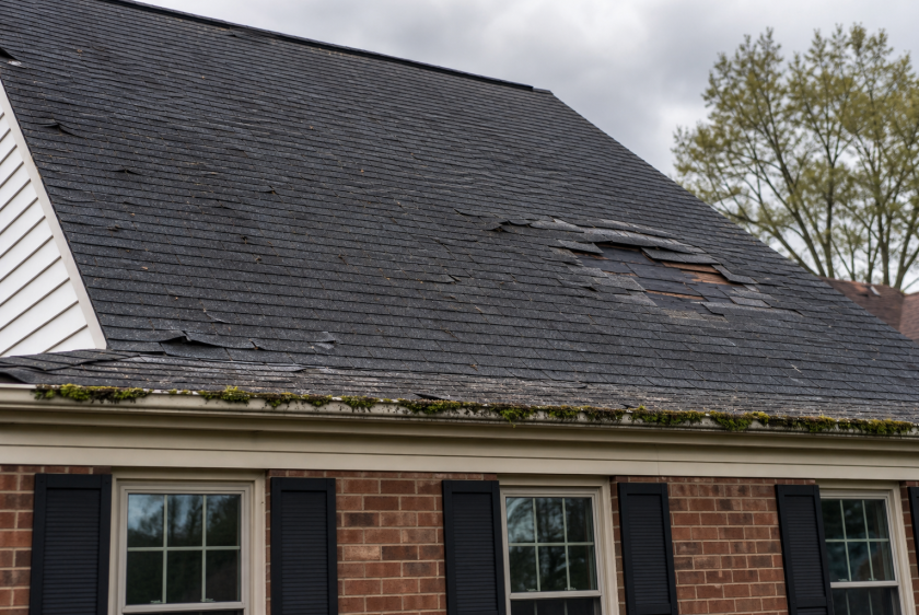 Damaged asphalt shingle roof on a Northern Virginia home showing signs you need a new roof